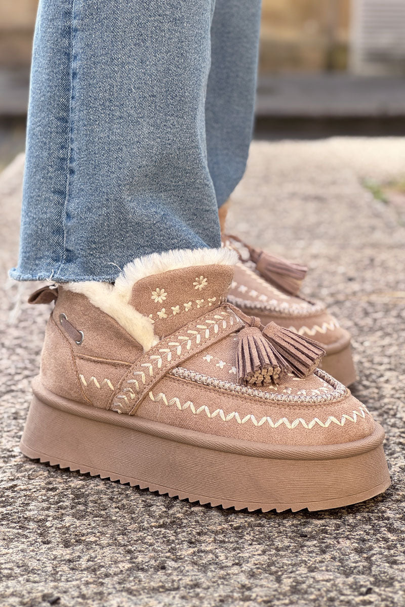 Boots fourrées beige à broderie dorée et pompons avec semelle plateforme