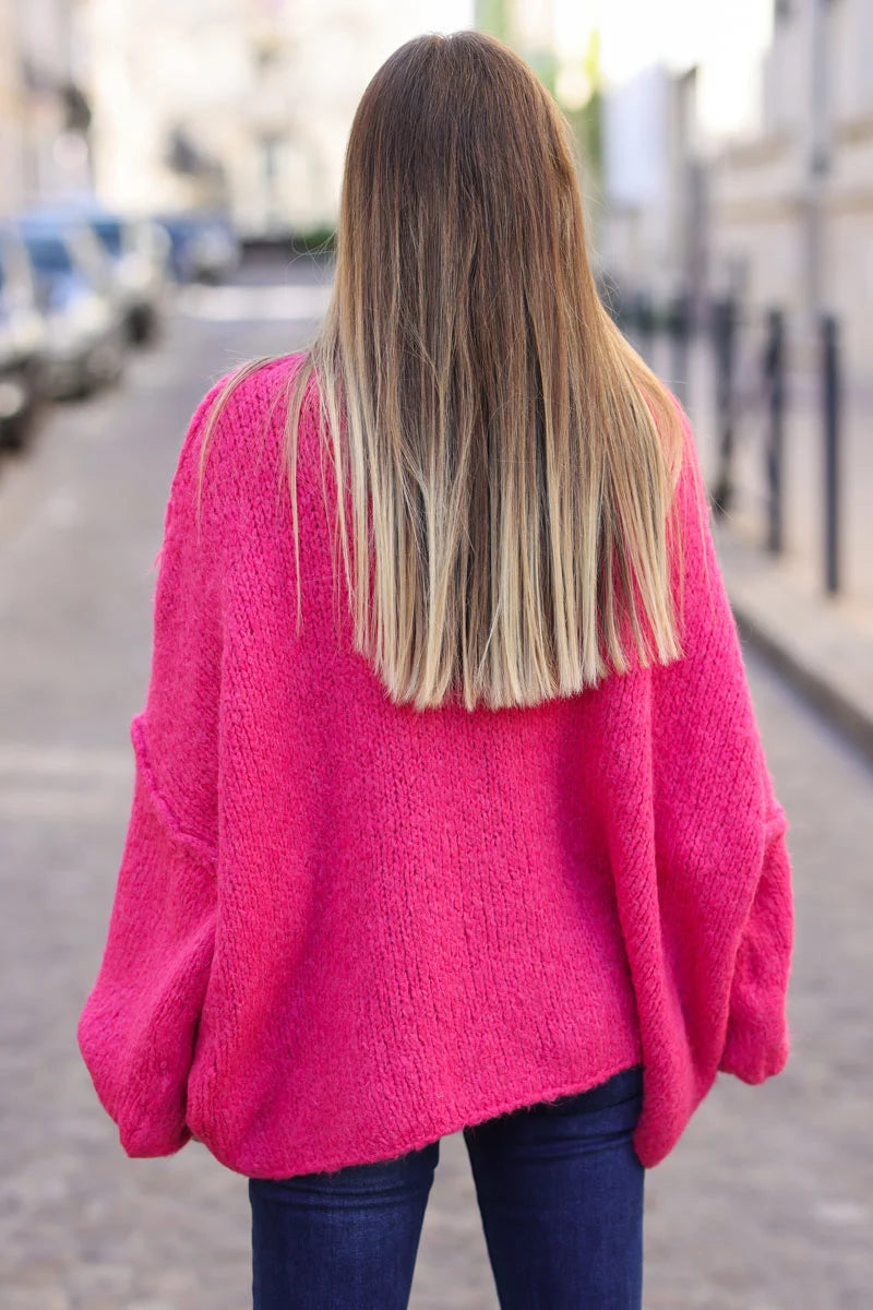 Gros pull large fuchsia en maille chaude couture apparente