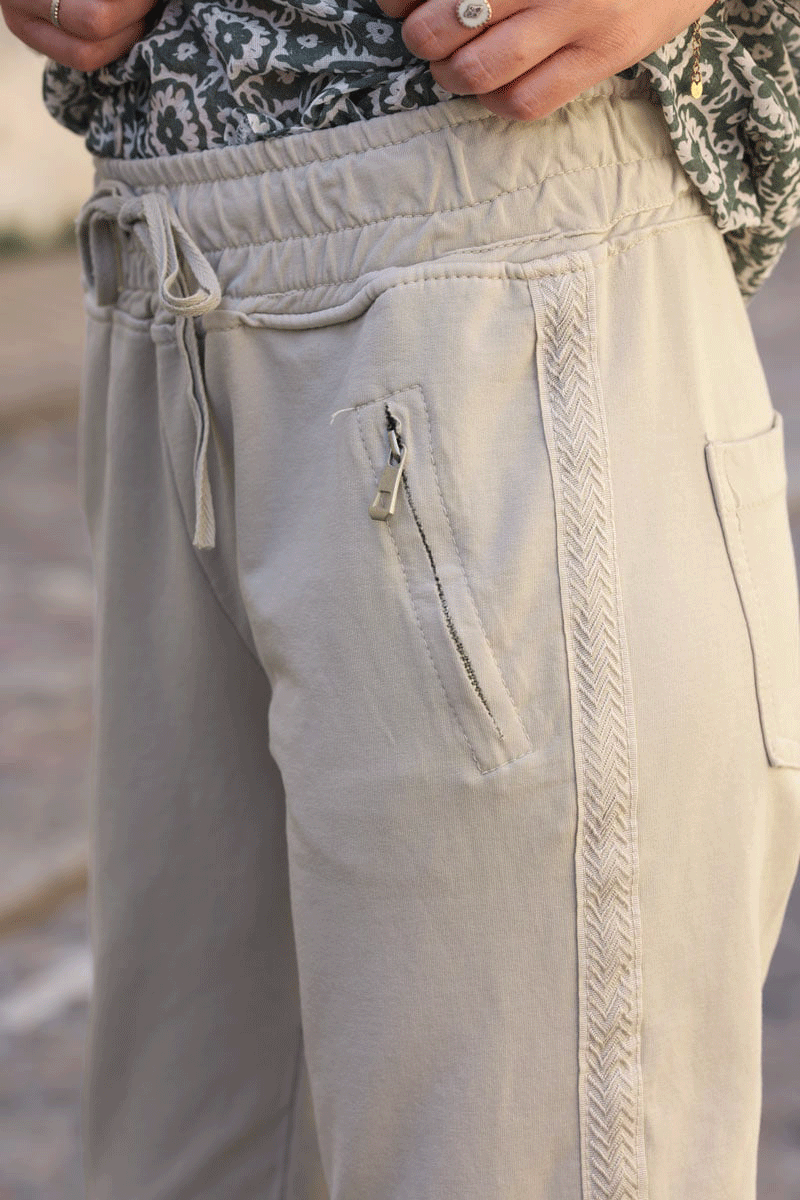 Jogging beige en coton ceinture élastique et poches zips liseré broderie chevrons